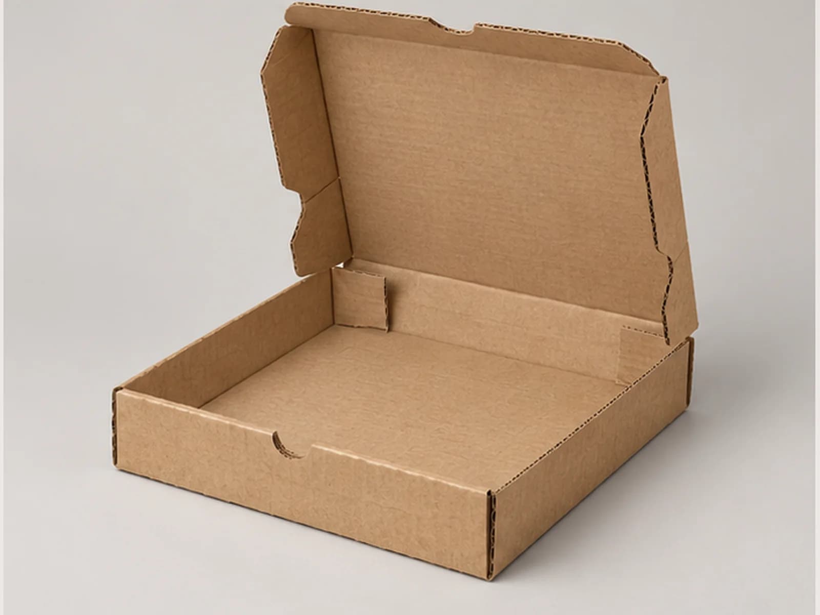 Open kraft pizza box showing internal structure and corrugated edges