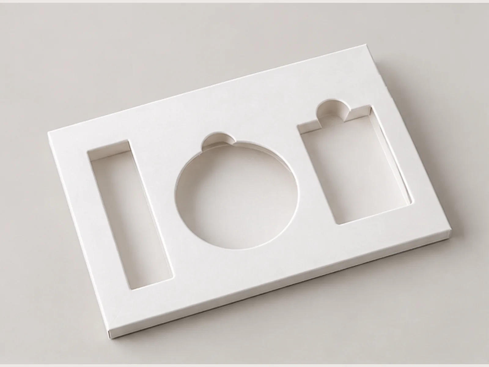 Thin cosmetic paperboard insert with precise die-cut openings