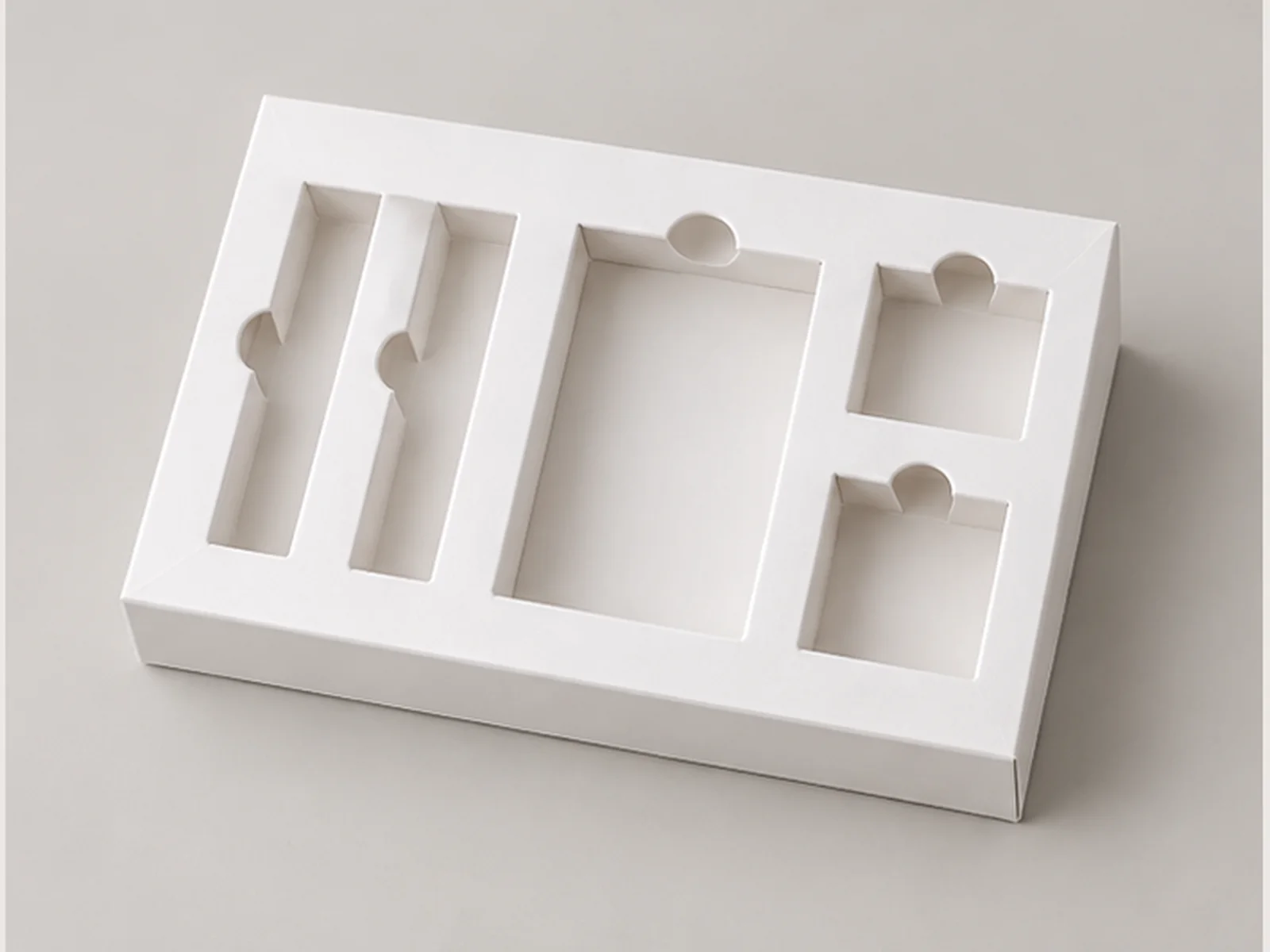 Precision die-cut paperboard insert with multiple slots